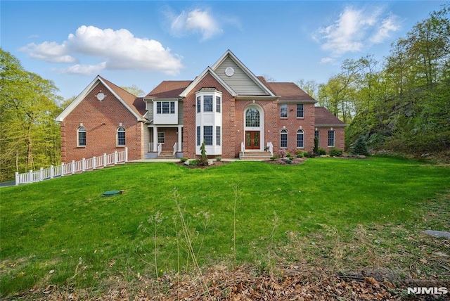 143 S Glen Rd, Kinnelon Borough, NJ 07405 - view of front of home with fence, a front lawn, and brick siding