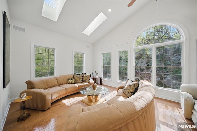 143 S Glen Rd, Kinnelon Borough, NJ 07405 - living area with visible vents, a skylight, wood finished floors, high vaulted ceiling, and baseboards