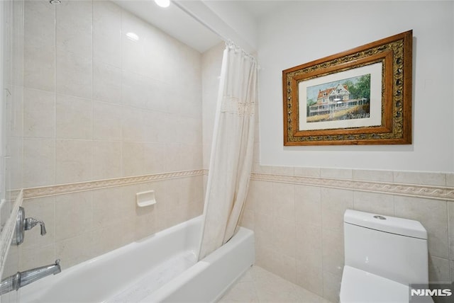 143 S Glen Rd, Kinnelon Borough, NJ 07405 - bathroom featuring toilet, tile walls, shower / bath combination with curtain, and a wainscoted wall
