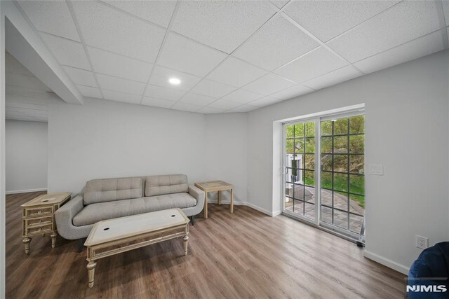 143 S Glen Rd, Kinnelon Borough, NJ 07405 - living area with baseboards, a drop ceiling, and wood finished floors