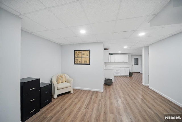 143 S Glen Rd, Kinnelon Borough, NJ 07405 - living area featuring baseboards, light wood-style flooring, and a paneled ceiling