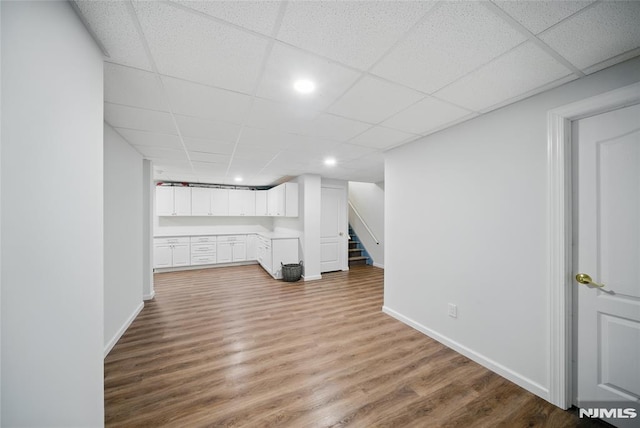 143 S Glen Rd, Kinnelon Borough, NJ 07405 - finished basement featuring baseboards, a drop ceiling, stairs, and wood finished floors