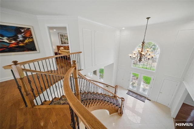 143 S Glen Rd, Kinnelon Borough, NJ 07405 - entryway with crown molding, a notable chandelier, french doors, and light wood-style flooring