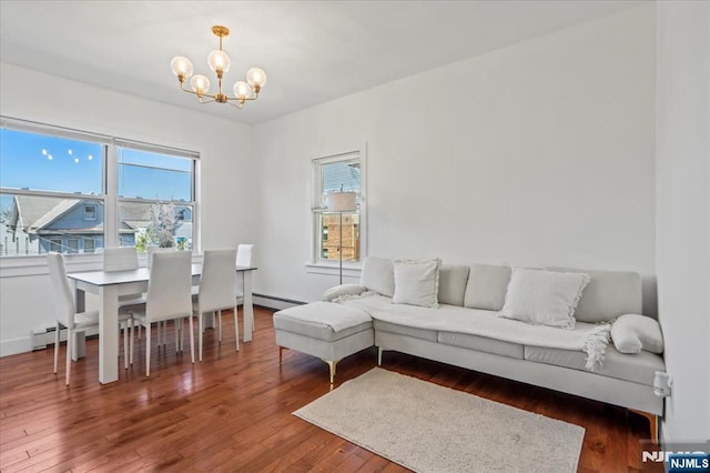 1026 Grove St, Irvington, NJ 07111 - living room featuring hardwood / wood-style floors, a baseboard radiator, a chandelier, and a wealth of natural light