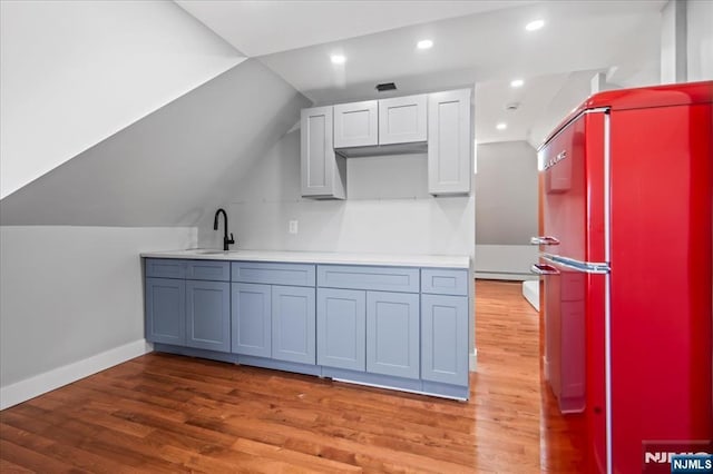 1026 Grove St, Irvington, NJ 07111 - kitchen featuring vaulted ceiling, fridge, light wood-type flooring, a sink, and baseboards