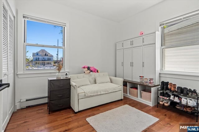 1026 Grove St, Irvington, NJ 07111 - sitting room featuring wood finished floors and a baseboard heating unit