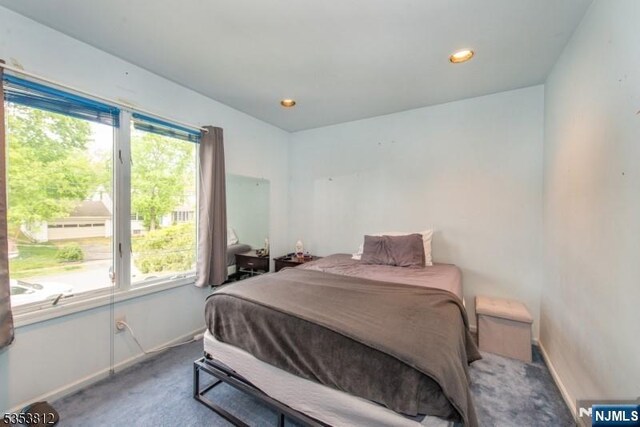 carpeted bedroom featuring baseboards and recessed lighting
