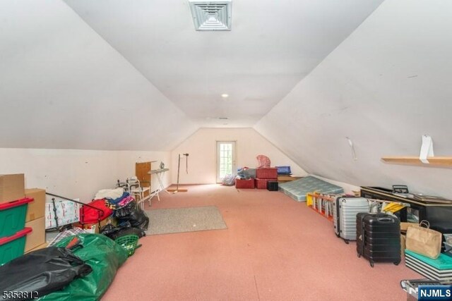 game room with carpet flooring, visible vents, and lofted ceiling