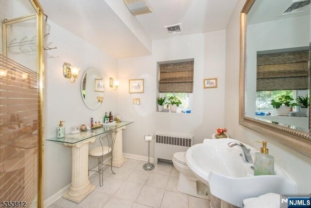 full bath with radiator, a wealth of natural light, a stall shower, and visible vents