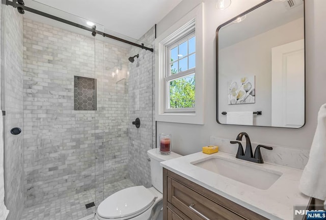 full bath with toilet, a shower stall, and vanity