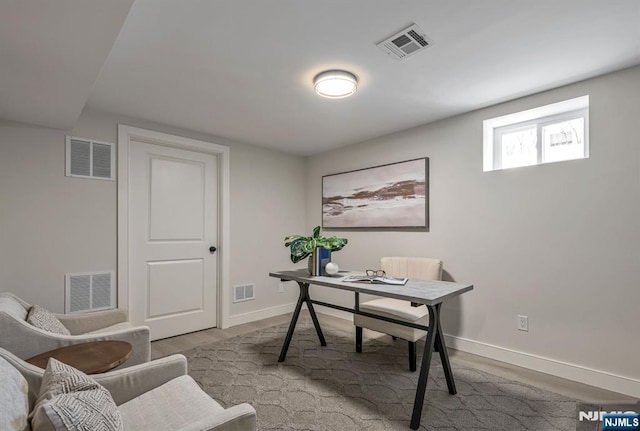 office area featuring visible vents and wood finished floors