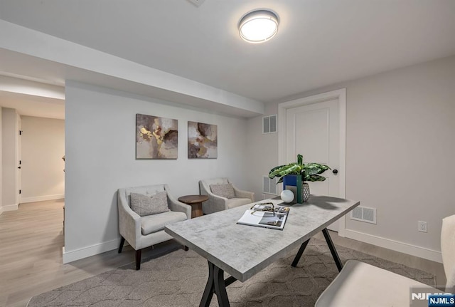 office with visible vents, baseboards, and light wood finished floors