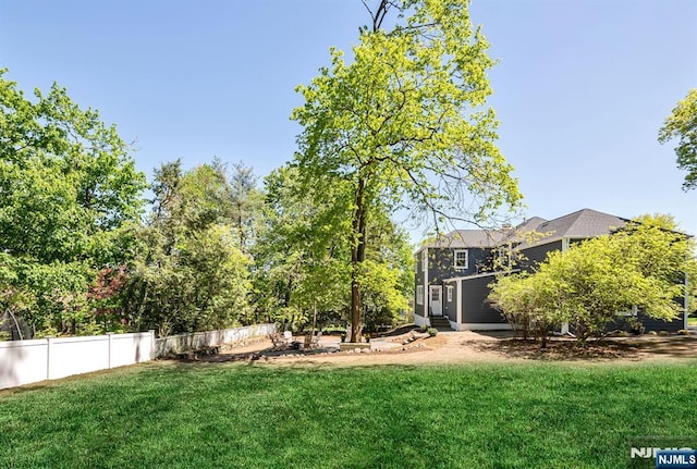 view of yard featuring fence and entry steps
