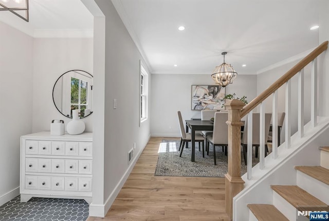 dining space with stairs, visible vents, ornamental molding, and an inviting chandelier