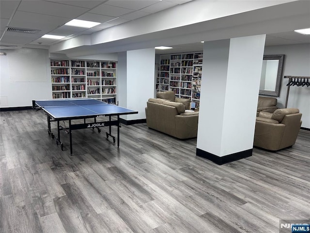 555 N Ave Unit 4C, Fort Lee, NJ 07024 - playroom featuring baseboards, a drop ceiling, built in shelves, and wood finished floors