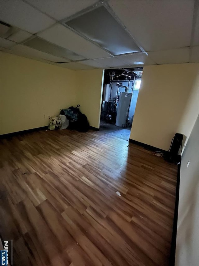 below grade area with wood finished floors and a paneled ceiling