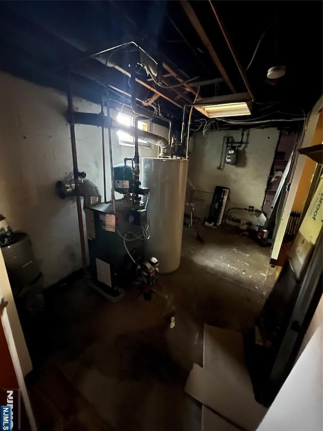 unfinished basement with a heating unit and water heater