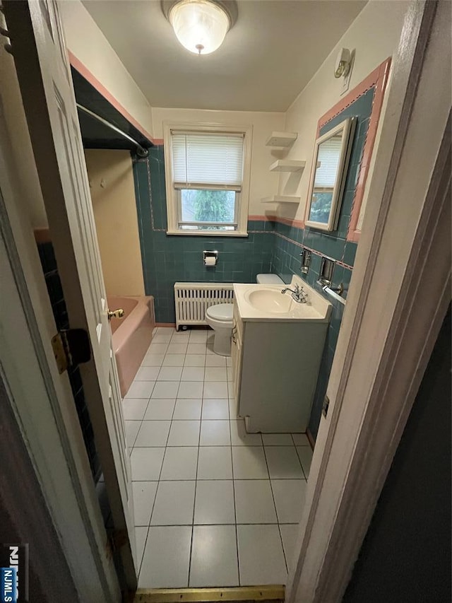 full bathroom featuring tile walls, tile patterned flooring, vanity, toilet, and radiator heating unit