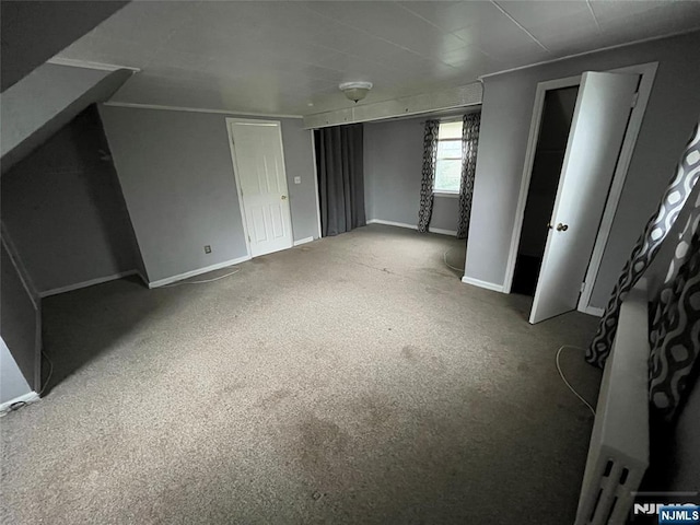 unfurnished bedroom with carpet floors and baseboards