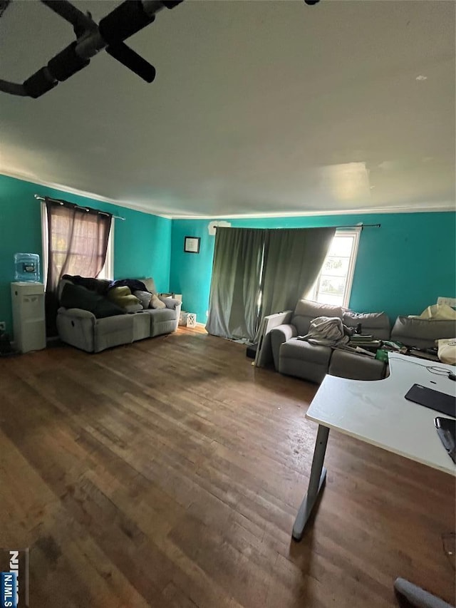 living room featuring ornamental molding and wood finished floors