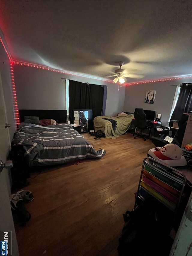 bedroom featuring a ceiling fan and wood finished floors