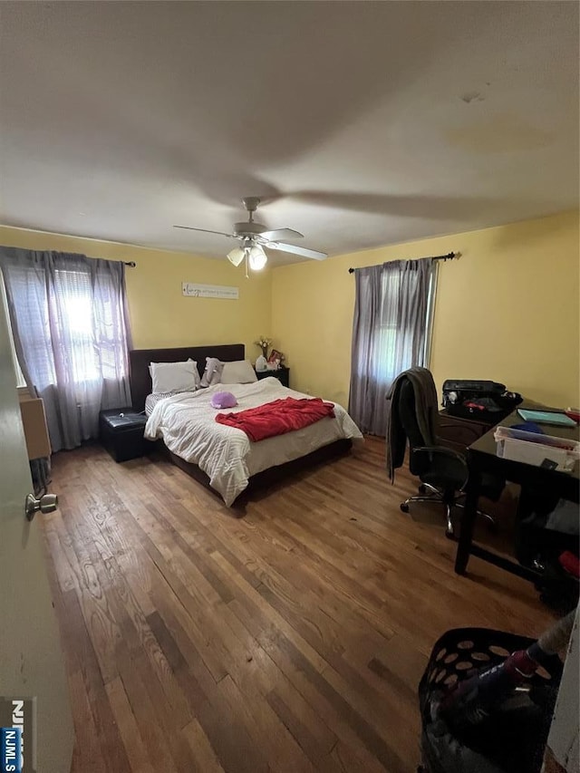 bedroom featuring ceiling fan and hardwood / wood-style flooring