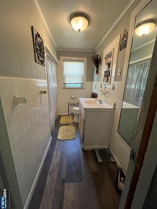 full bath featuring crown molding, tile walls, wood finished floors, toilet, and radiator