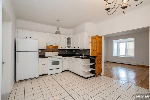 118 W 49th St, Bayonne, NJ 07002 - kitchen with dark countertops, open shelves, a baseboard radiator, under cabinet range hood, and white appliances