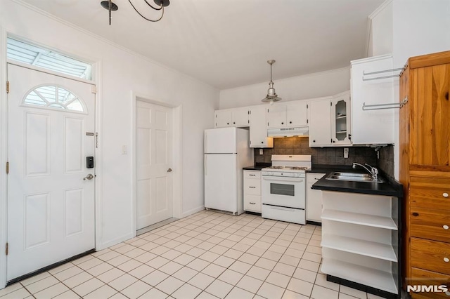 118 W 49th St, Bayonne, NJ 07002 - kitchen with backsplash, dark countertops, white cabinets, under cabinet range hood, and white appliances