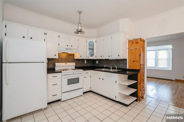 118 W 49th St, Bayonne, NJ 07002 - kitchen featuring dark countertops, a sink, a baseboard radiator, under cabinet range hood, and white appliances