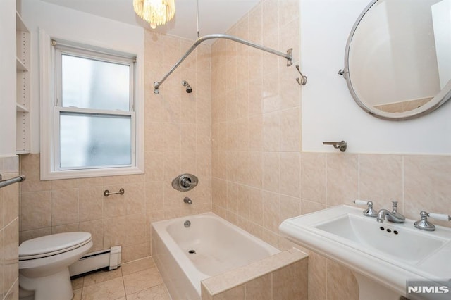 118 W 49th St, Bayonne, NJ 07002 - full bathroom featuring a healthy amount of sunlight, tile walls, baseboard heating, and toilet