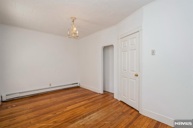 118 W 49th St, Bayonne, NJ 07002 - unfurnished room featuring crown molding, arched walkways, baseboard heating, and hardwood / wood-style flooring