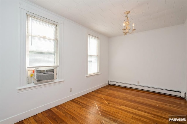 118 W 49th St, Bayonne, NJ 07002 - spare room featuring a baseboard heating unit, ornamental molding, an inviting chandelier, and hardwood / wood-style floors