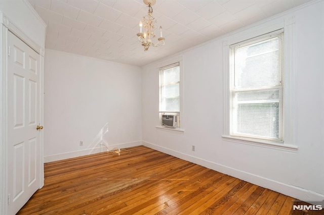 118 W 49th St, Bayonne, NJ 07002 - unfurnished room featuring crown molding, baseboards, light wood-style floors, and a notable chandelier