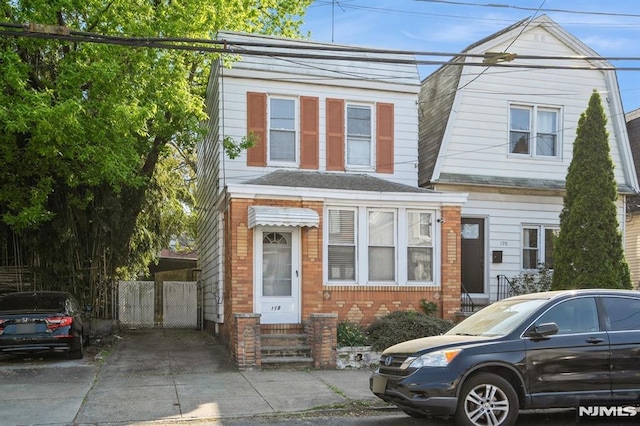 118 W 49th St, Bayonne, NJ 07002 - view of front of home with entry steps, driveway, and brick siding