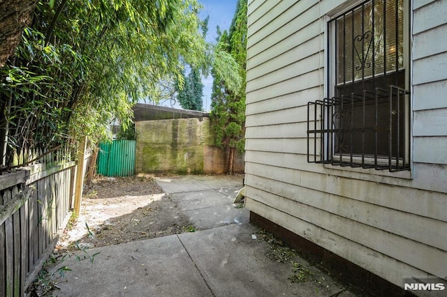 118 W 49th St, Bayonne, NJ 07002 - view of property exterior with a patio and fence