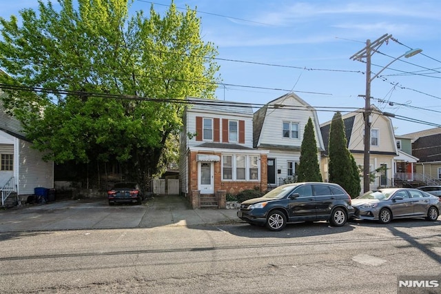 118 W 49th St, Bayonne, NJ 07002 - view of front of property with brick siding, a gambrel roof, and entry steps