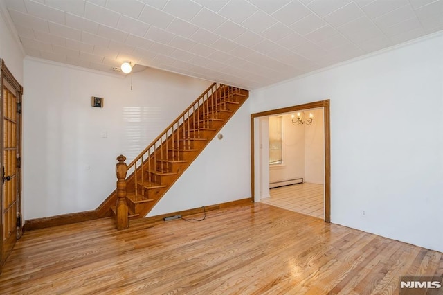 118 W 49th St, Bayonne, NJ 07002 - unfurnished living room featuring crown molding, stairs, wood finished floors, a baseboard heating unit, and a chandelier