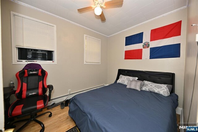 72 Van Winkle Ave, Garfield, NJ 07026 - bedroom featuring ceiling fan, crown molding, baseboard heating, wood finished floors, and cooling unit