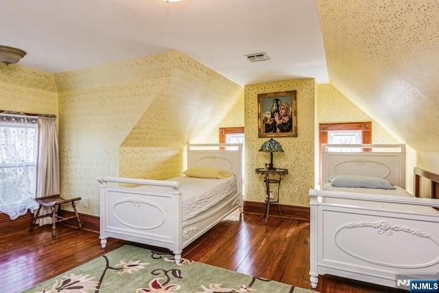 142 Brookfield Ave, Nutley, NJ 07110 - bedroom with visible vents, wood-type flooring, vaulted ceiling, and wallpapered walls