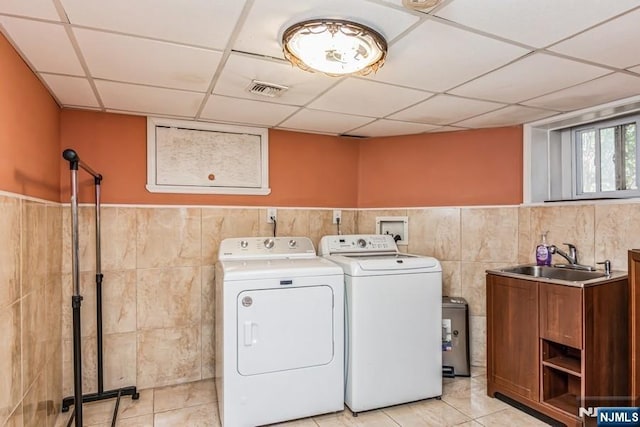 142 Brookfield Ave, Nutley, NJ 07110 - clothes washing area with laundry area, washing machine and clothes dryer, tile walls, wainscoting, and a sink