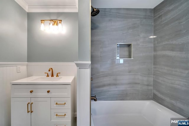 full bath with vanity, ornamental molding, wainscoting, and shower / bath combination
