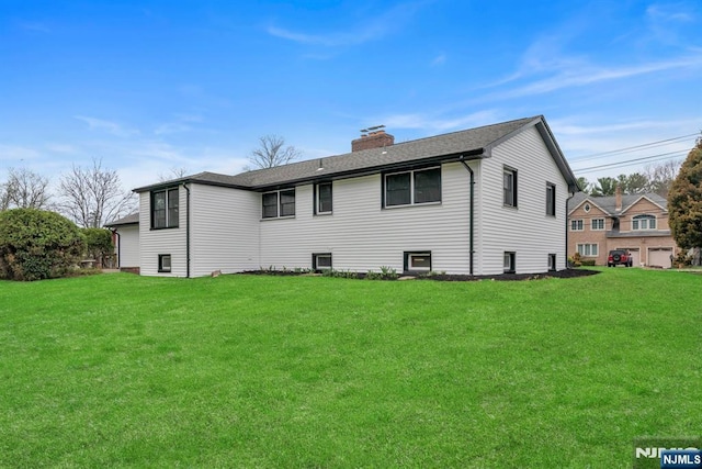 back of property featuring a lawn and a chimney