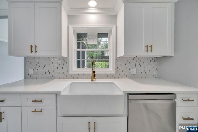 kitchen with a sink, stainless steel dishwasher, backsplash, and white cabinetry