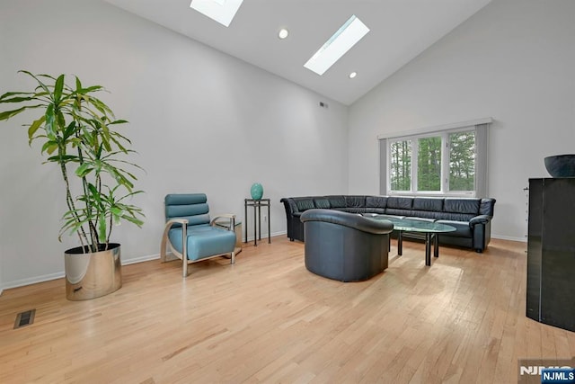 living room featuring visible vents, wood finished floors, high vaulted ceiling, recessed lighting, and a skylight
