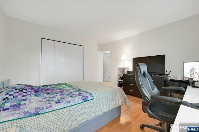 bedroom featuring a closet and light wood-style floors