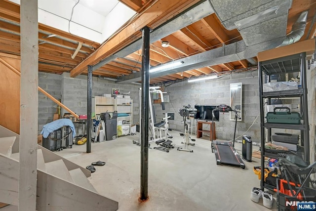 workout room featuring concrete block wall