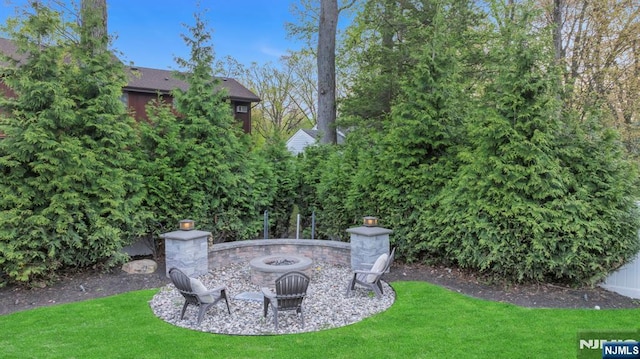 view of yard with a fire pit