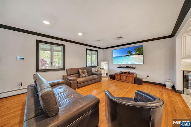 living room with visible vents, ornamental molding, baseboards, recessed lighting, and light wood finished floors