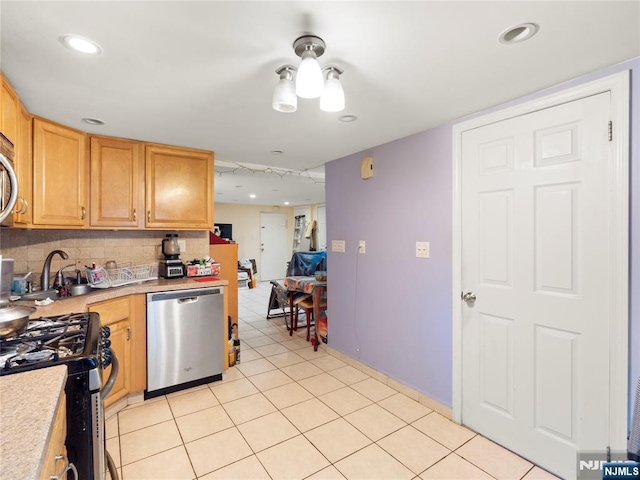 kitchen featuring decorative backsplash, appliances with stainless steel finishes, light countertops, light tile patterned floors, and recessed lighting